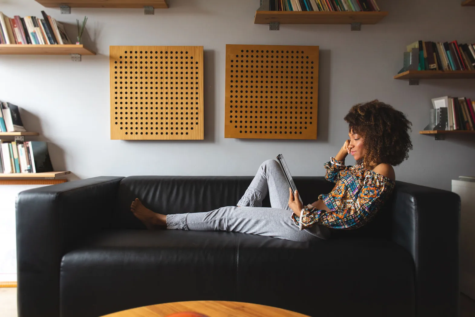 woman in brown shirt admires tablet